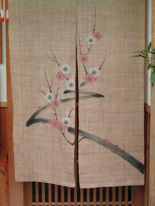 The distinctive zig zag ume plum branches and ume flowers on a noren entrance textile