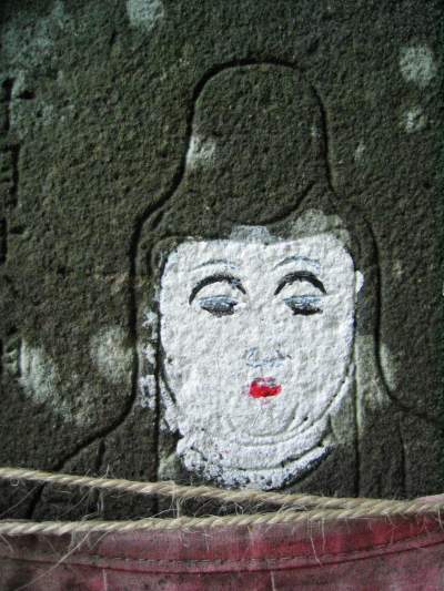 Feminine Japanese Buddha on stone and primitively painted