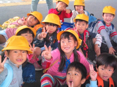 Japanese elementary school kids in caps.