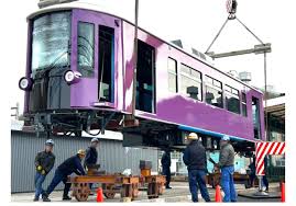 The first new super modern Kyotram being lowered to the tracks.