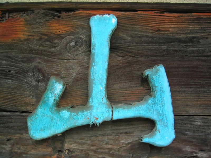 An old handmade handicraft shop sign with the Chinese character for mountain