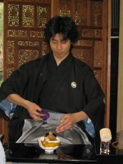 Tea ceremony teacher seated and preparing tea in Kyoto