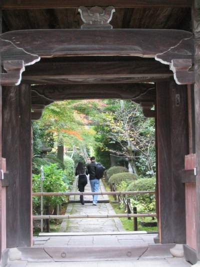 A couple walking through a Buddhist temple in Kyoto