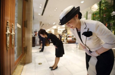 YJPT's Japan travel services are as precise as these women welcoming customers at Tokyo's prestigious Mitsukoshi Department store!